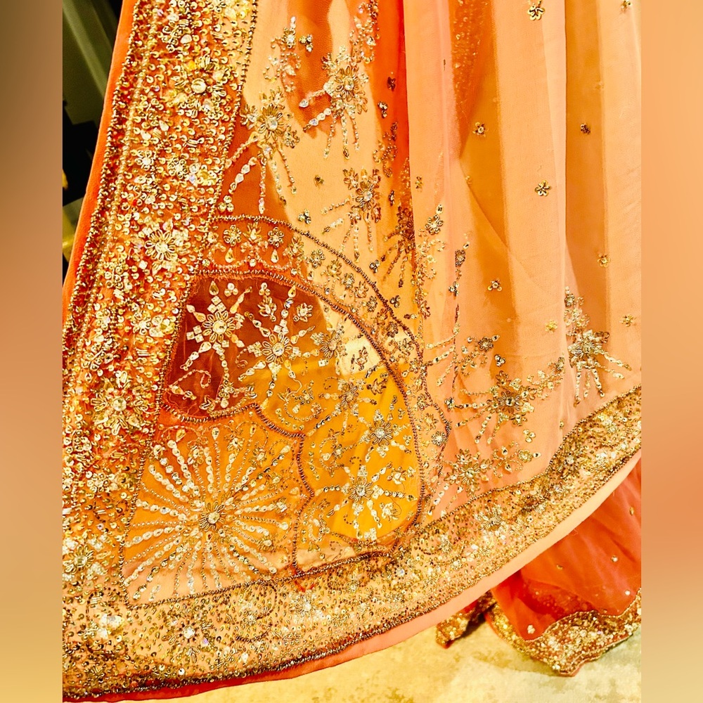 Ombré beige to salmon pink saree eloquently enhanced with dainty bead work